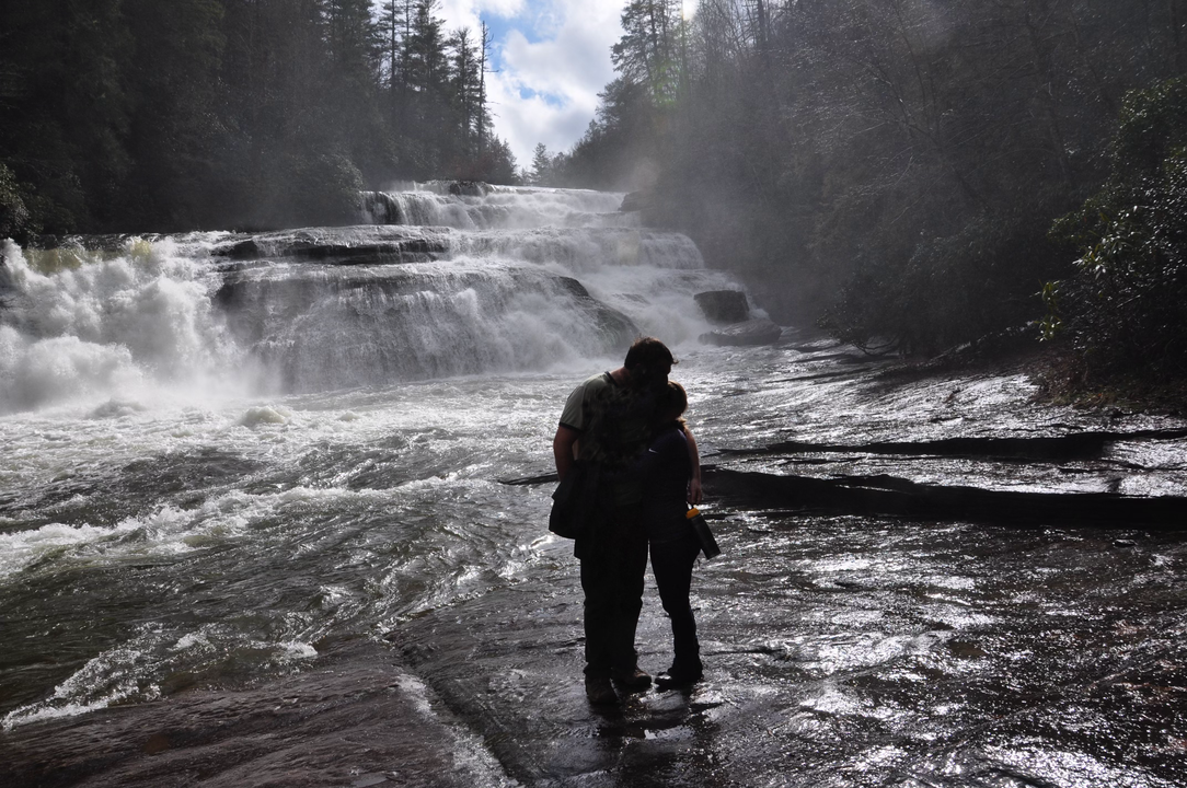 Couple stanidng in front of Dupont Forest Waterfall