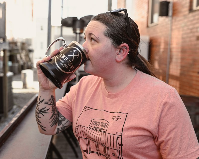 Person enjoying a beverage at Mica Town Brewing in downtown Marion